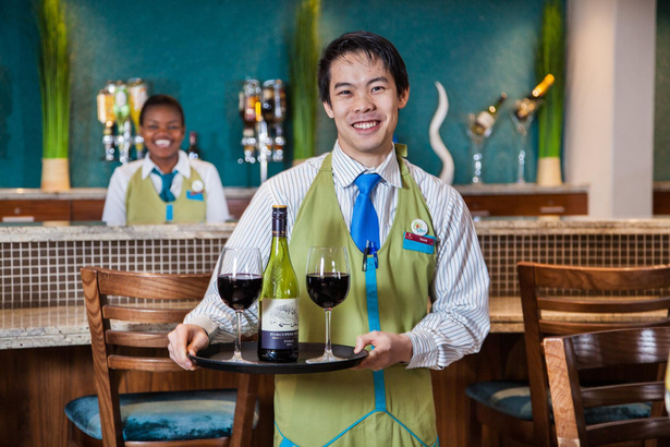 Photo of bar staff with tray containing Wine glasses and bottle of whine. NightOwl Media, Corporate Photography. Photographer based in Pretoria & Johannesburg, Gauteng, South Africa. Videographer, Marketing, Incentive, hotel, lodge, travel